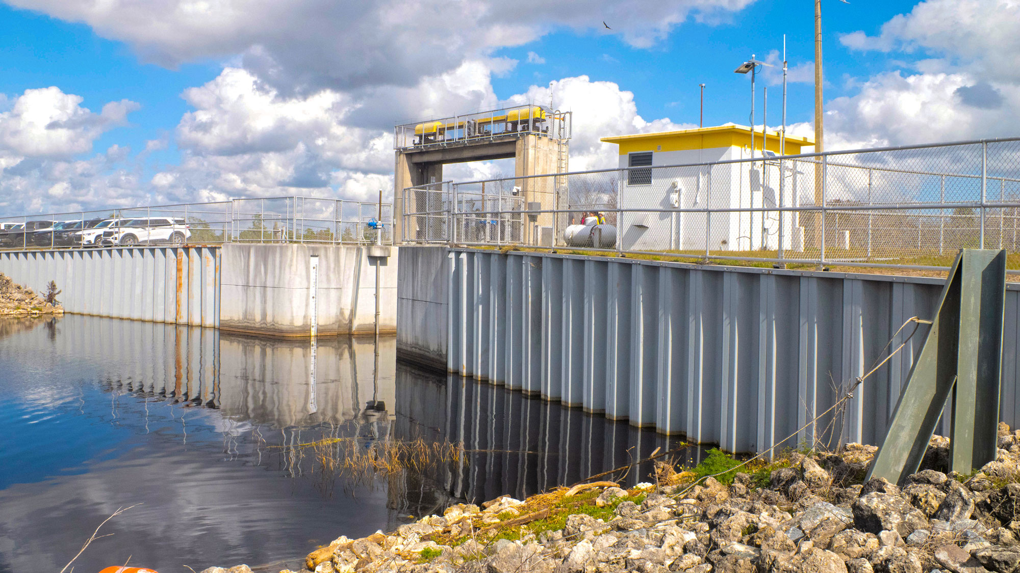 Water sitting in front of a water flow control station building.